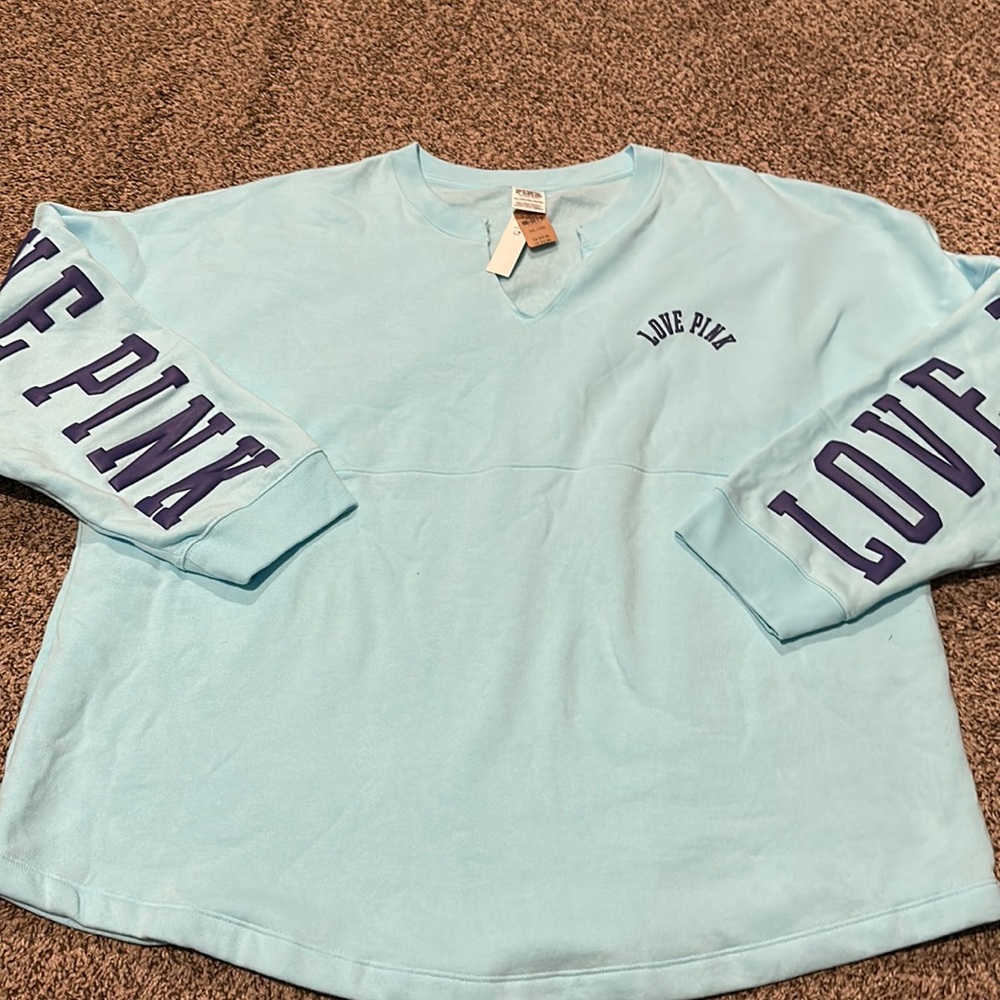 New with tags PINK blue pullover with writing down back of arms size XXL